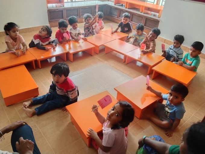 Children doing a craft activity at classroom desks