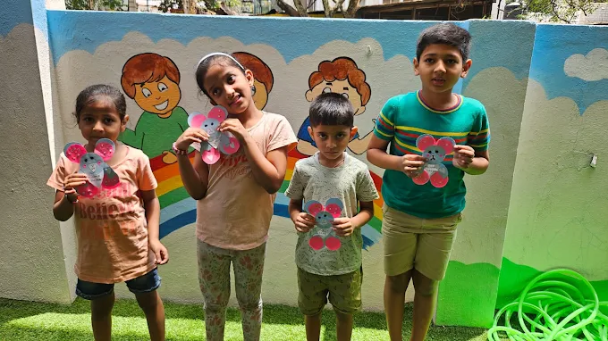 Children holding colourful handmade crafts