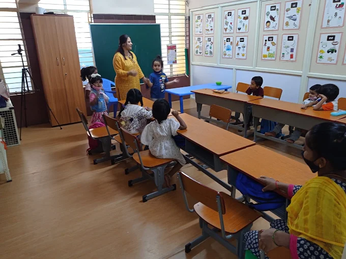 Teacher engaging children in classroom activity