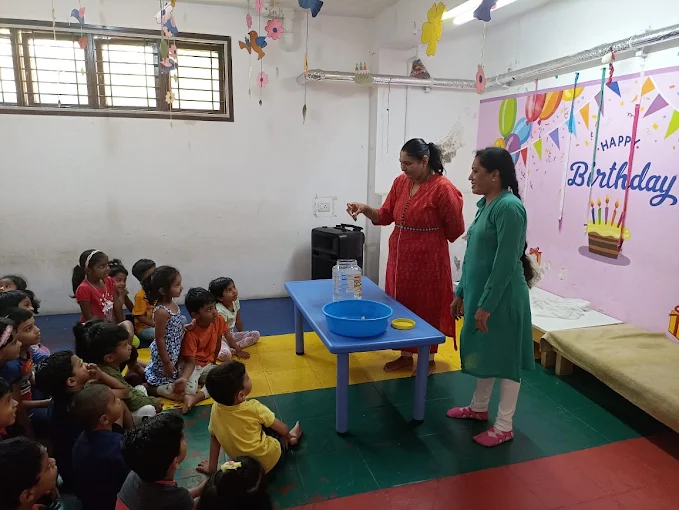 Teachers demonstrating a science activity to children
