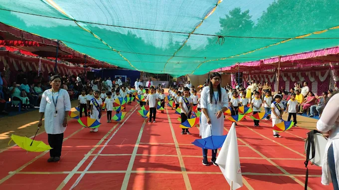 Children in colourful umbrella parade for Sports Day