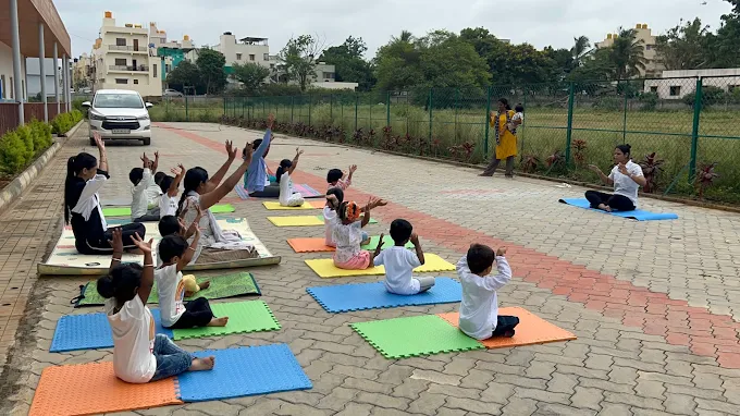 Children doing yoga stretches outdoors